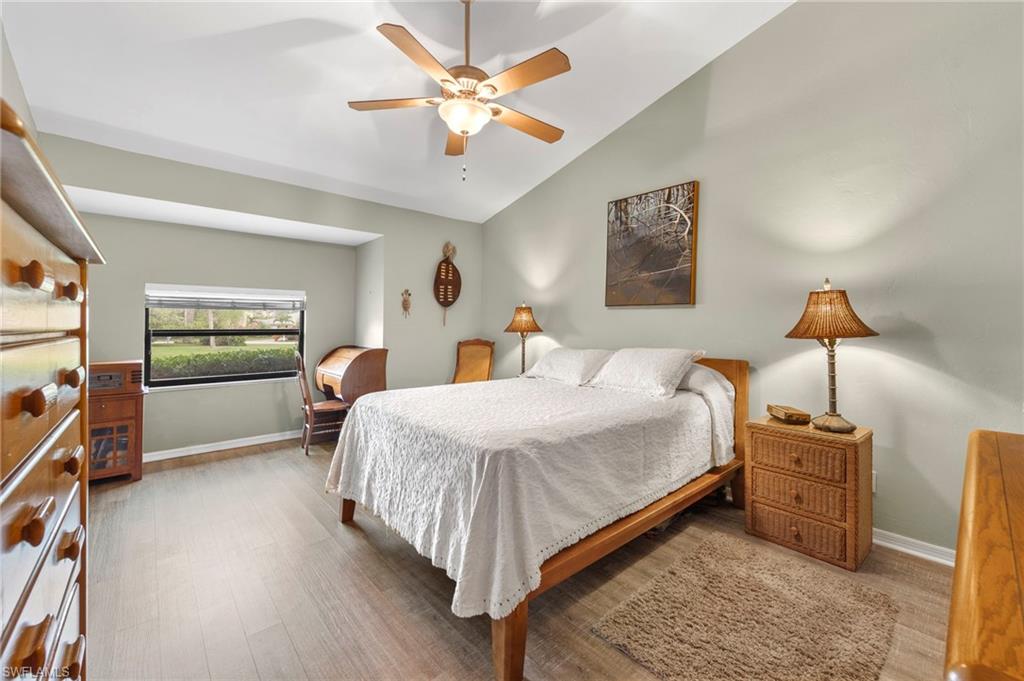5120 Alpha Court Naples, FL 34105 - Photo 8 of 18 a bedroom with a bed and a chandelier