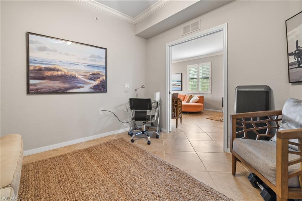 9735 Acqua Court, Unit 618 Naples, FL 34113 - Photo 17 of 50 a living room with furniture and a flat screen tv