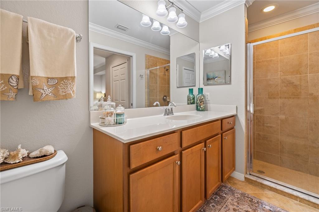 9735 Acqua Court, Unit 618 Naples, FL 34113 - Photo 24 of 50 a bathroom with a sink a toilet a mirror and shower