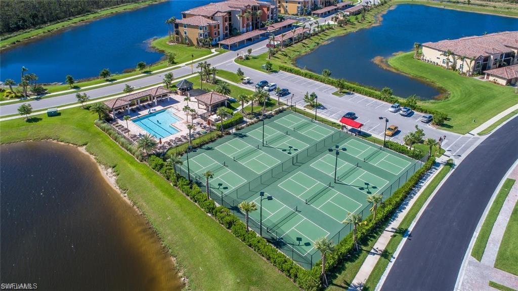 9735 Acqua Court, Unit 618 Naples, FL 34113 - Photo 49 of 50 view of a tennis ground with a large pool