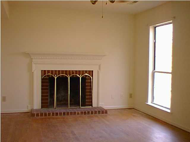 805 Harris Road Charlottesville, VA 22902 - Photo 2 of 9 an empty room with a fireplace and window
