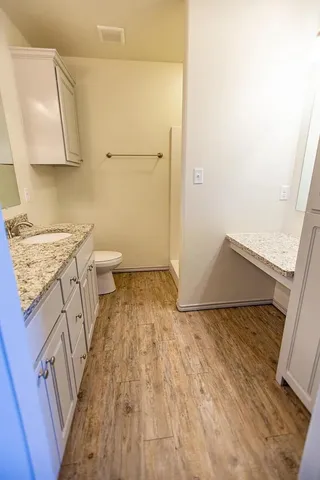 a view of a bathroom with wooden floor and a sink