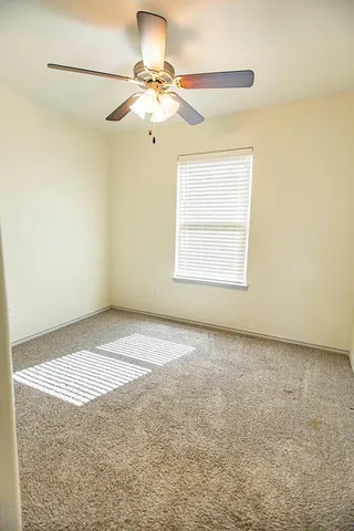 a view of an empty room with a window