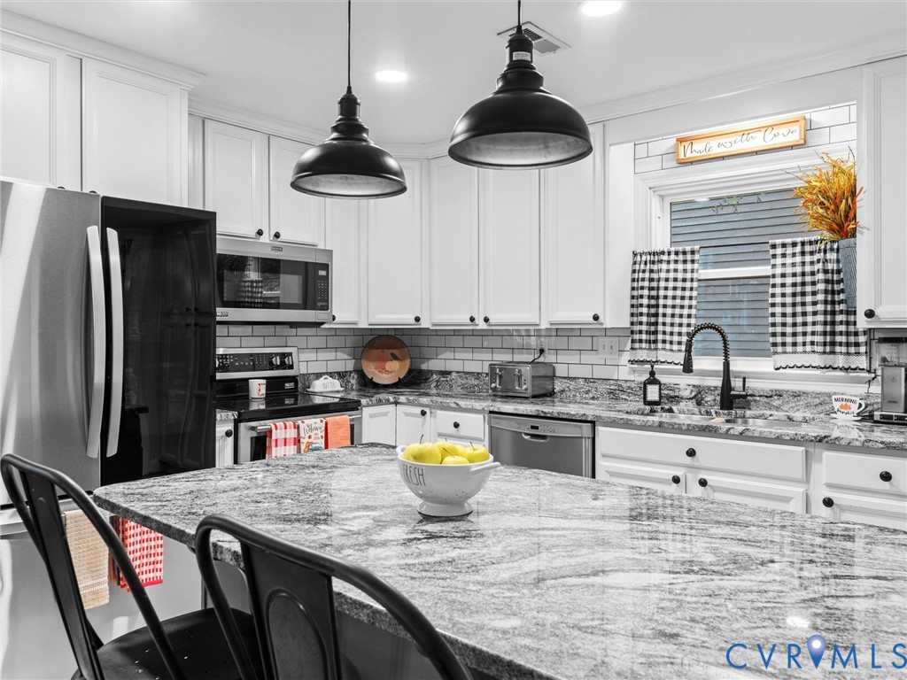 419 Walton Park Road Midlothian, VA 23114 - Photo 2 of 47 a kitchen with stainless steel appliances granite countertop a sink a stove and a refrigerator