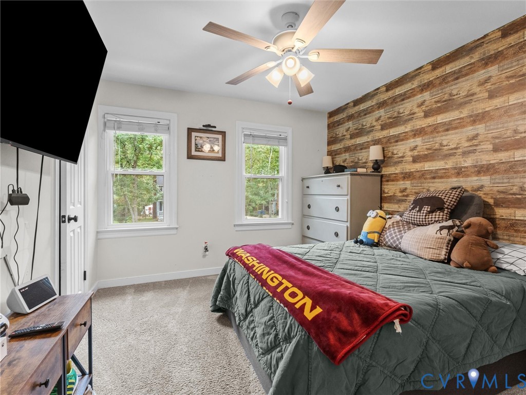 419 Walton Park Road Midlothian, VA 23114 - Photo 26 of 47 a bedroom with a bed and a chandelier