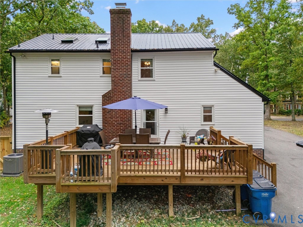 419 Walton Park Road Midlothian, VA 23114 - Photo 40 of 47 a view of a deck with a table and chair under an umbrella