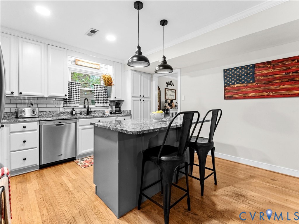 419 Walton Park Road Midlothian, VA 23114 - Photo 4 of 47 a kitchen with a table chairs and white cabinets