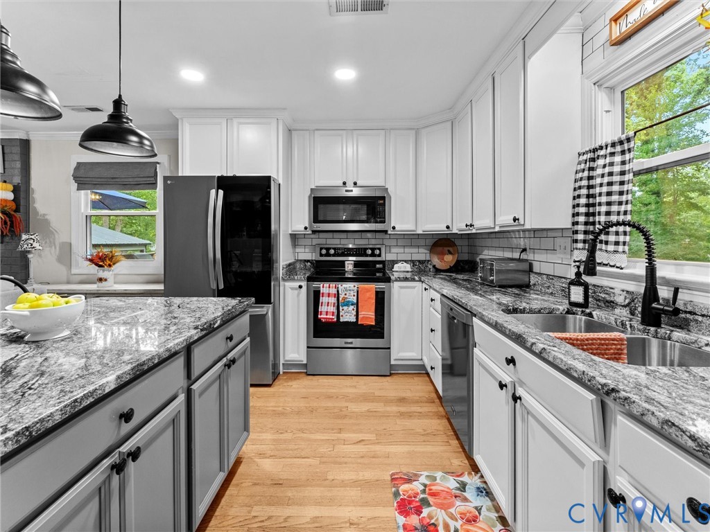419 Walton Park Road Midlothian, VA 23114 - Photo 5 of 47 a kitchen with stainless steel appliances granite countertop a sink stove and refrigerator