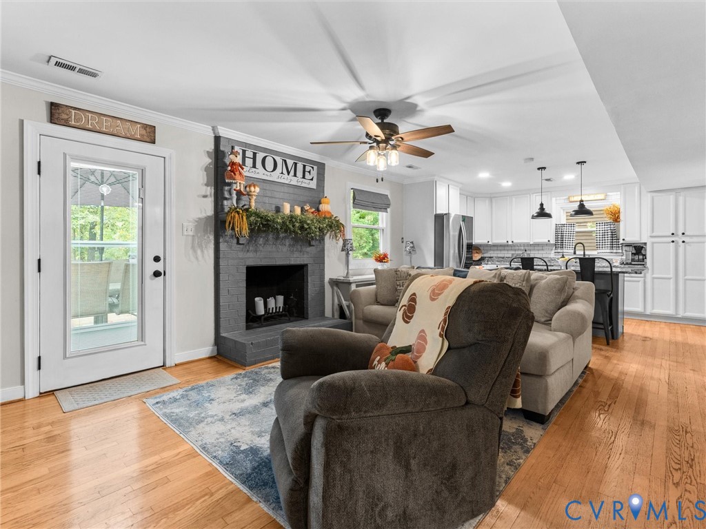 419 Walton Park Road Midlothian, VA 23114 - Photo 10 of 47 a living room with furniture a fireplace and a ceiling fan