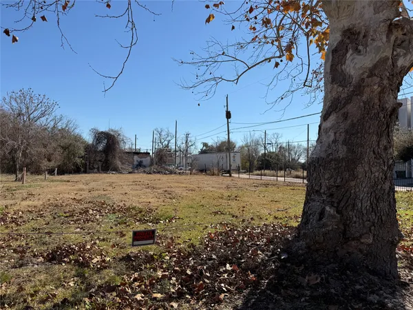 a view of a yard with wooden fence