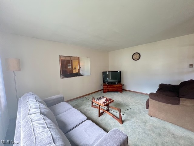 Living room featuring carpet and baseboards