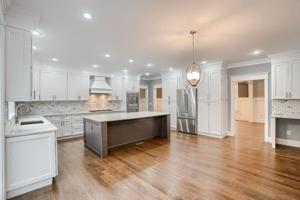 19 Stoney Brook Road Hopkinton, MA 01748 - Photo 15 of 41 a large kitchen with granite countertop a stove top oven a sink a counter space and cabinets
