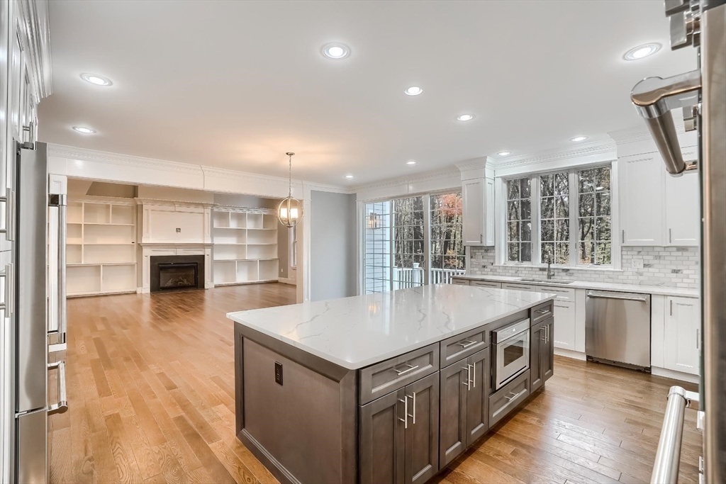 19 Stoney Brook Road Hopkinton, MA 01748 - Photo 17 of 41 a kitchen with stainless steel appliances granite countertop a lot of counter space and wooden floors
