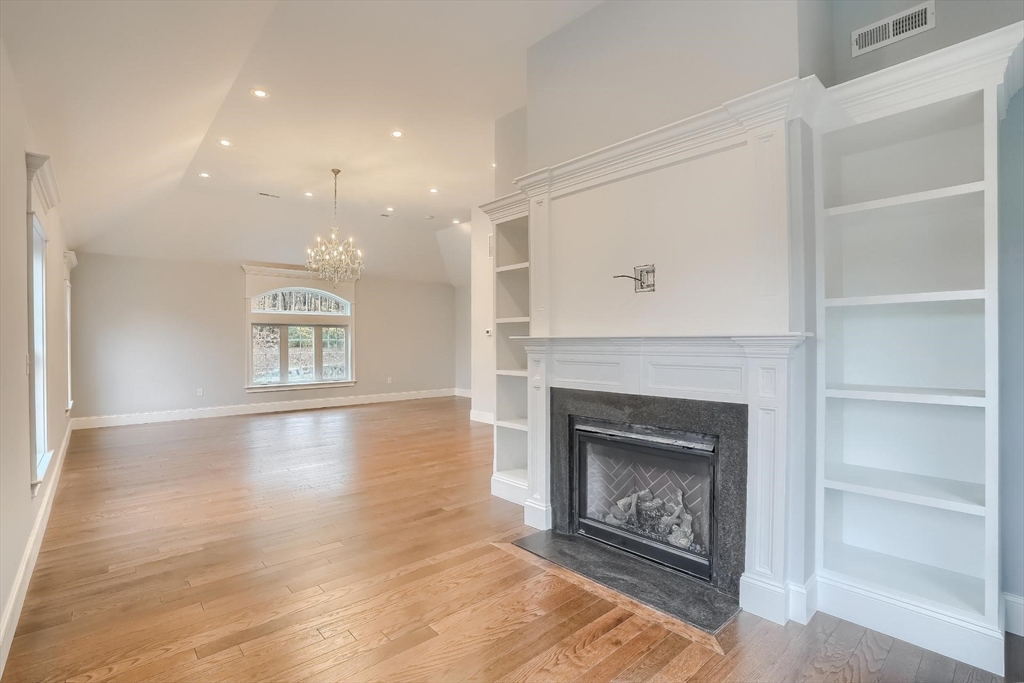 19 Stoney Brook Road Hopkinton, MA 01748 - Photo 24 of 41 a living room with a fireplace and a wooden floor