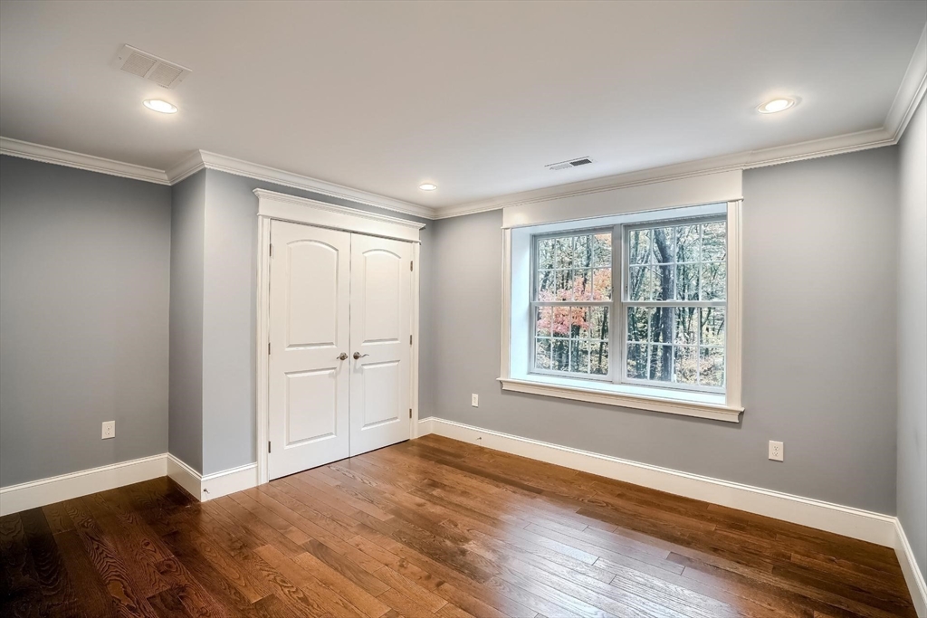19 Stoney Brook Road Hopkinton, MA 01748 - Photo 29 of 41 a view of an empty room with wooden floor and a window
