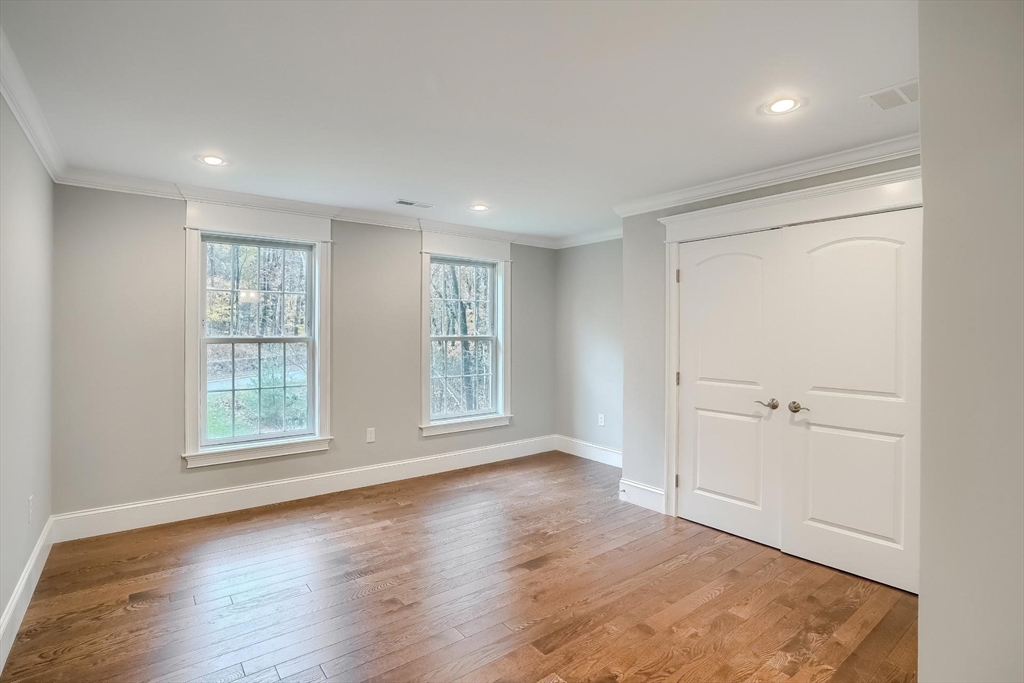 19 Stoney Brook Road Hopkinton, MA 01748 - Photo 31 of 41 an empty room with wooden floor and windows