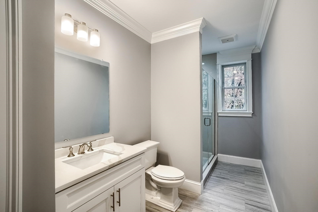 19 Stoney Brook Road Hopkinton, MA 01748 - Photo 33 of 41 a bathroom with a granite countertop toilet a sink and mirror