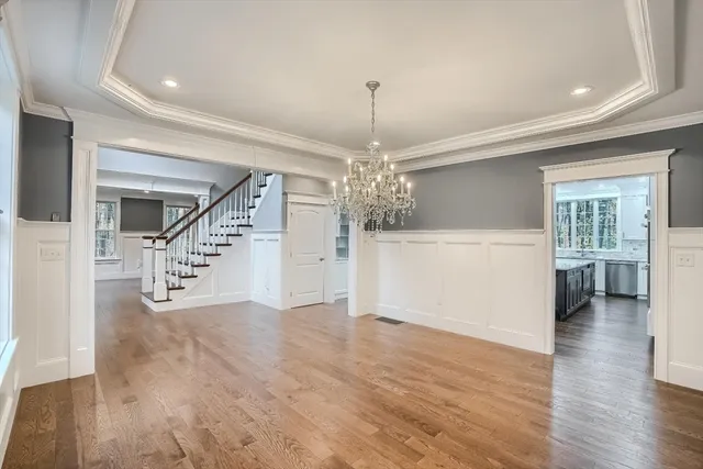 a view of a livingroom with wooden floor and stairs