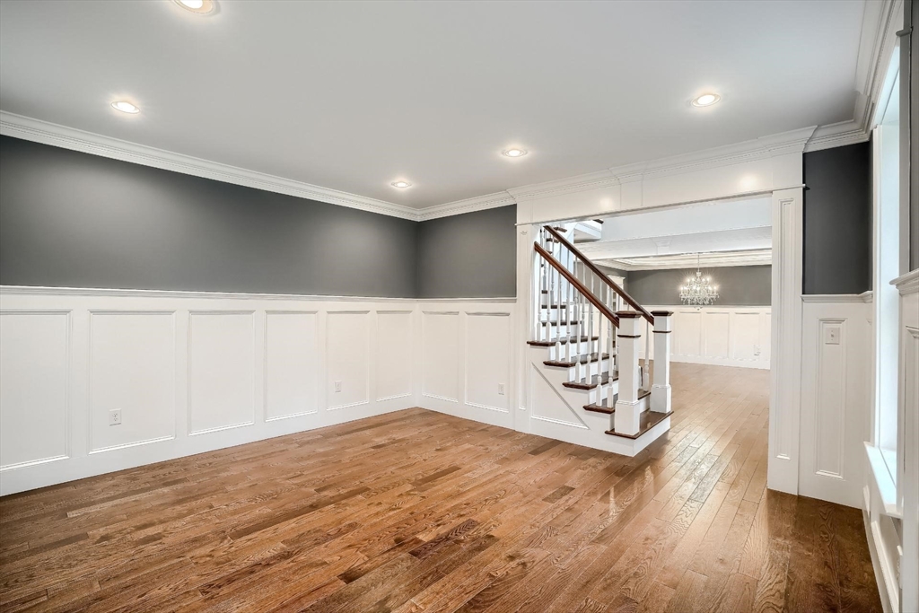 19 Stoney Brook Road Hopkinton, MA 01748 - Photo 7 of 41 an empty room with wooden floor staircase and windows