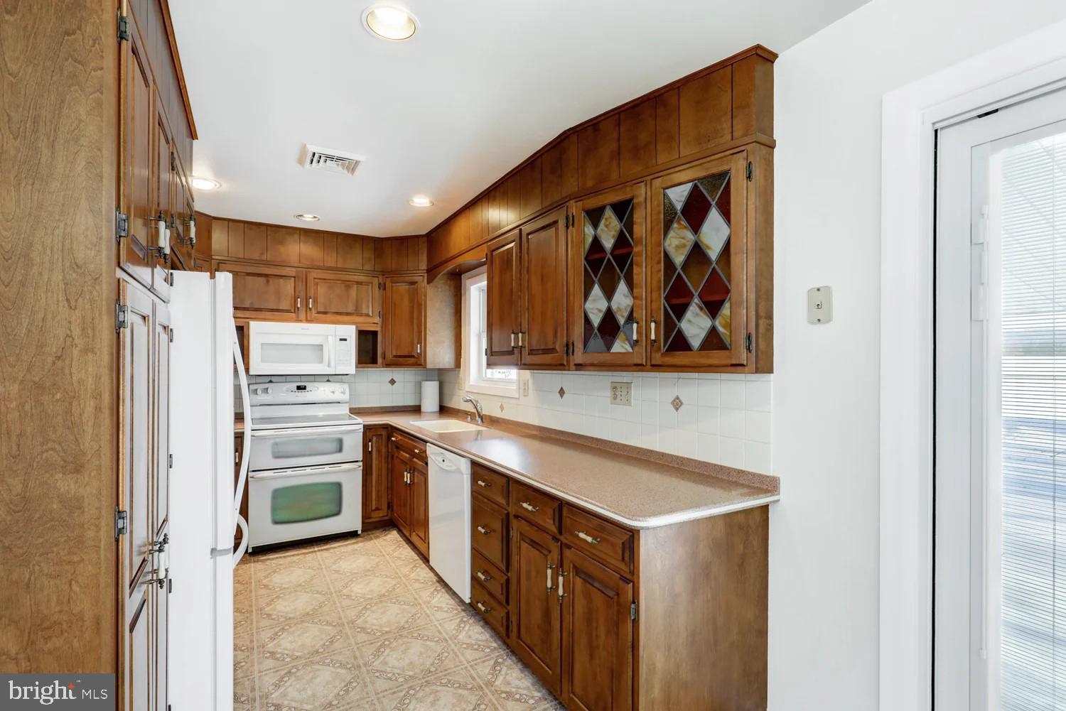 720 South Cocalico Road Denver, PA 17517 - Photo 8 of 14 a kitchen with stainless steel appliances granite countertop a stove and a refrigerator