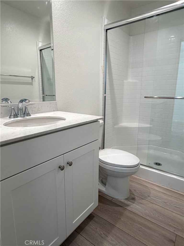 7631 Rubyred Gln Drive Riverside, CA 92507 - Photo 10 of 17 a bathroom with a sink a toilet and shower
