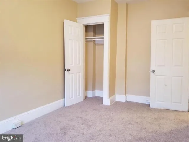 a view of a hallway with closet area