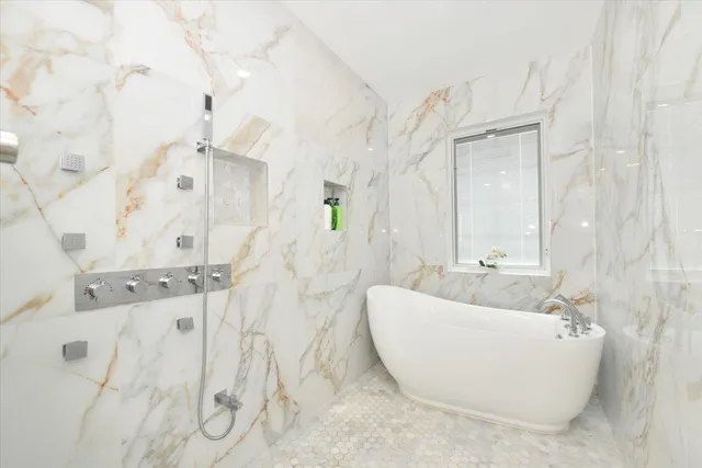 a bathroom with a bathtub and shower