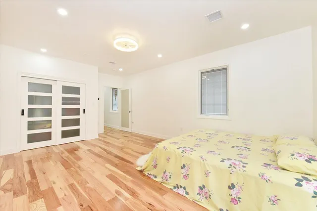 a bedroom with a bed and a window