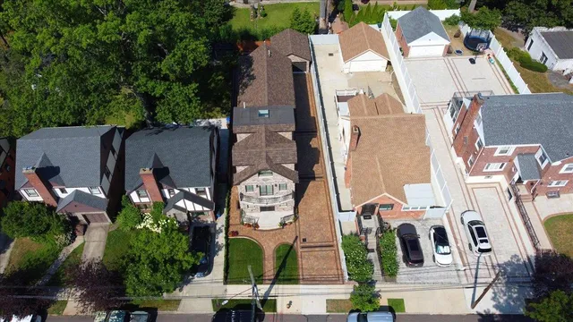 an aerial view of residential houses with outdoor space and parking