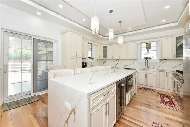 a large white kitchen with a large window
