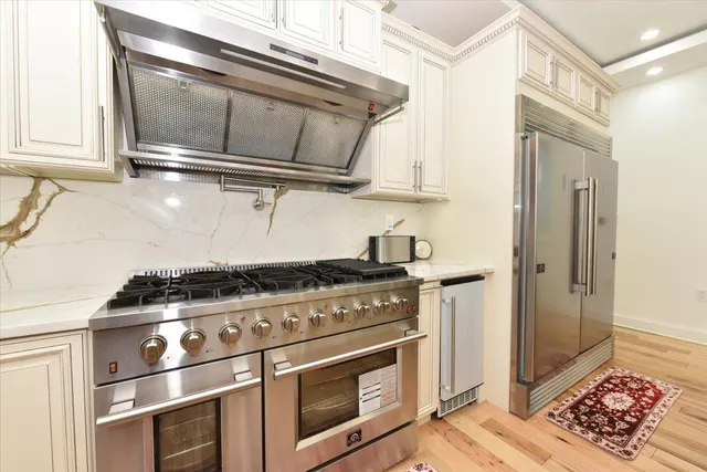 a stove top oven sitting inside of a kitchen