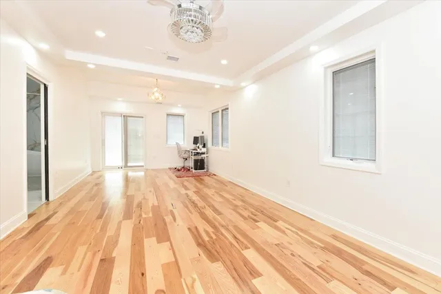 a view of a room with wooden floor and a window