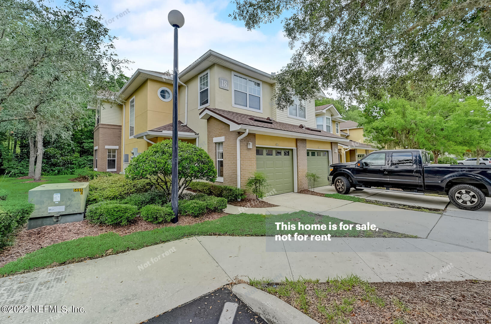 5663 Greenland Road, Unit 1801 Jacksonville, FL 32258 - Photo 11 of 26 a front view of a house with a garden and parking