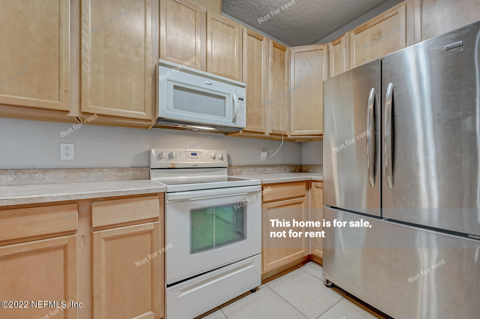 5663 Greenland Road, Unit 1801 Jacksonville, FL 32258 - Photo 13 of 26 a kitchen with stainless steel appliances granite countertop a refrigerator a microwave oven with white cabinets