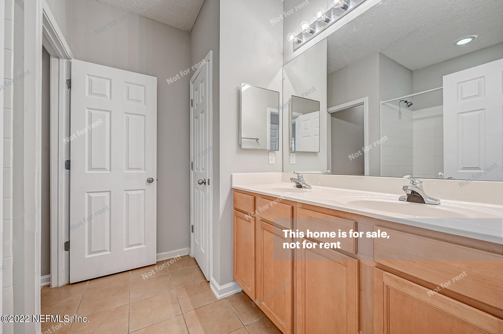 5663 Greenland Road, Unit 1801 Jacksonville, FL 32258 - Photo 19 of 26 a bathroom with a double vanity sink and mirror