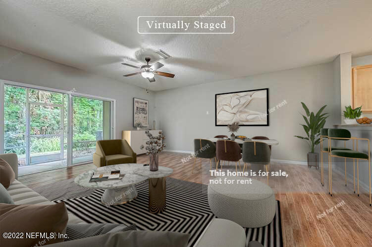 5663 Greenland Road, Unit 1801 Jacksonville, FL 32258 - Photo 2 of 26 a living room with furniture a rug potted plant and a large window