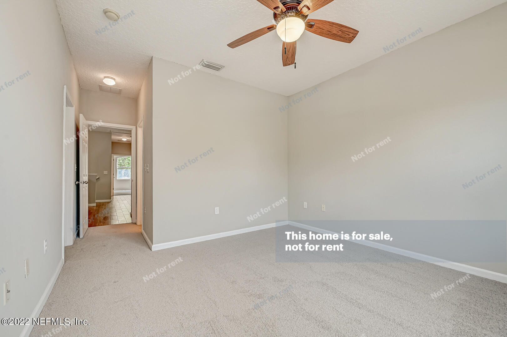 5663 Greenland Road, Unit 1801 Jacksonville, FL 32258 - Photo 23 of 26 an empty room with a ceiling fan and carpet