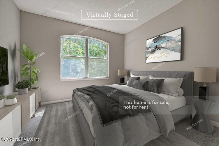 5663 Greenland Road, Unit 1801 Jacksonville, FL 32258 - Photo 3 of 26 a bed sitting in a bedroom next to a window