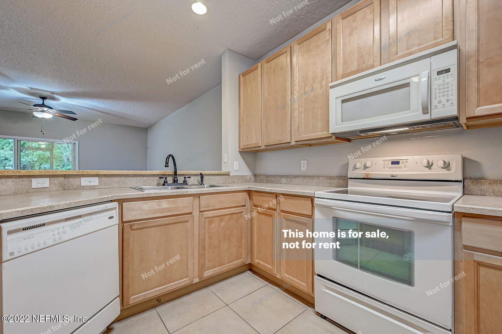 5663 Greenland Road, Unit 1801 Jacksonville, FL 32258 - Photo 4 of 26 a kitchen with granite countertop white cabinets stainless steel appliances and a sink