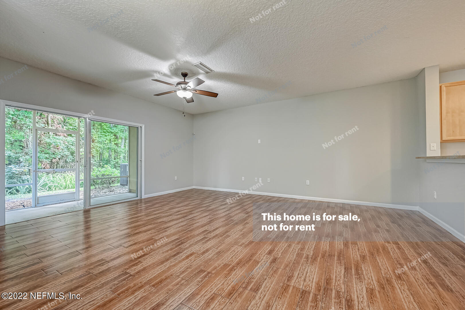 5663 Greenland Road, Unit 1801 Jacksonville, FL 32258 - Photo 6 of 26 a view of an empty room with wooden floor and a window