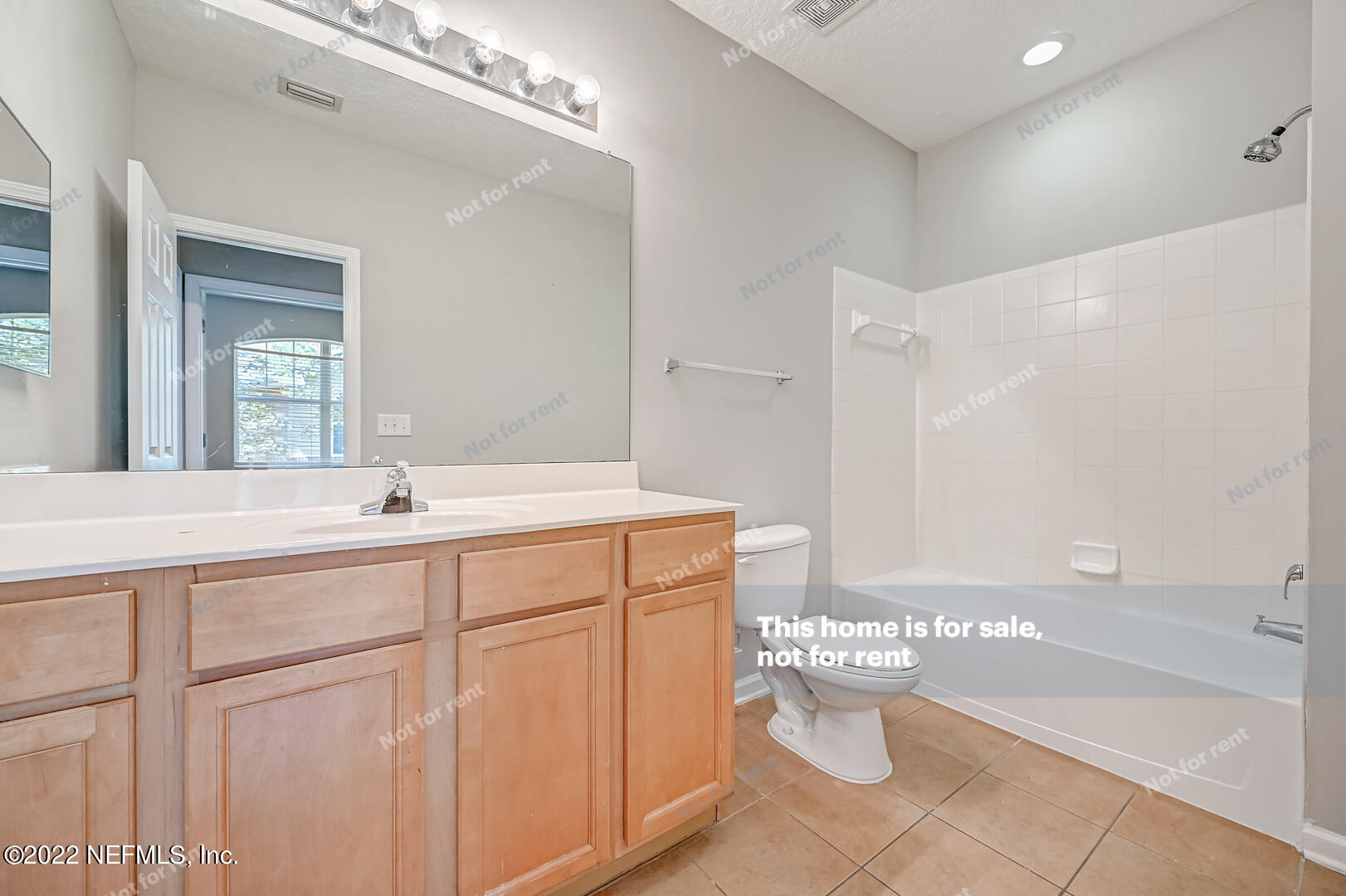5663 Greenland Road, Unit 1801 Jacksonville, FL 32258 - Photo 8 of 26 a bathroom with a sink mirror and toilet