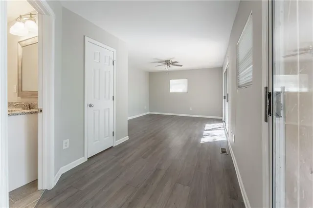 wooden floor in an empty room with a window