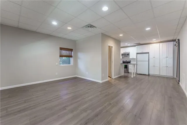 a view of empty room with wooden floor