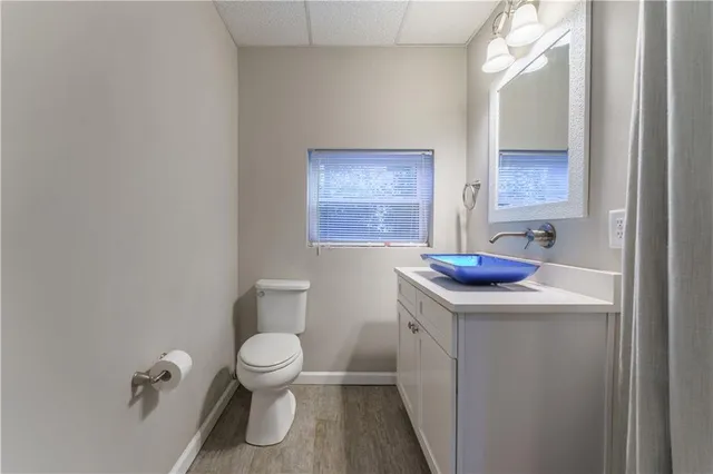 a bathroom with a toilet a sink and a window