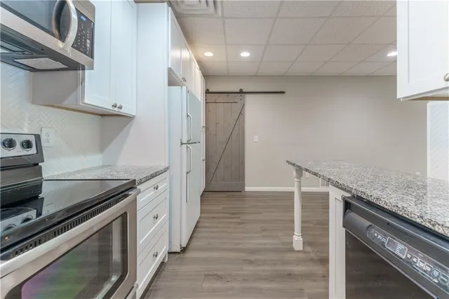a kitchen with cabinets and stainless steel appliances
