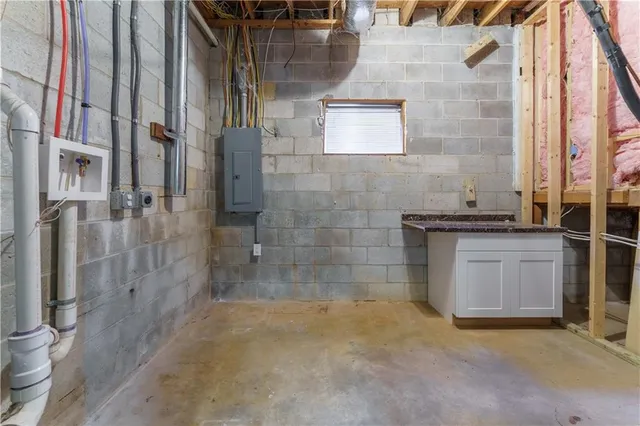 a bathroom with a granite countertop sink a toilet and a shower