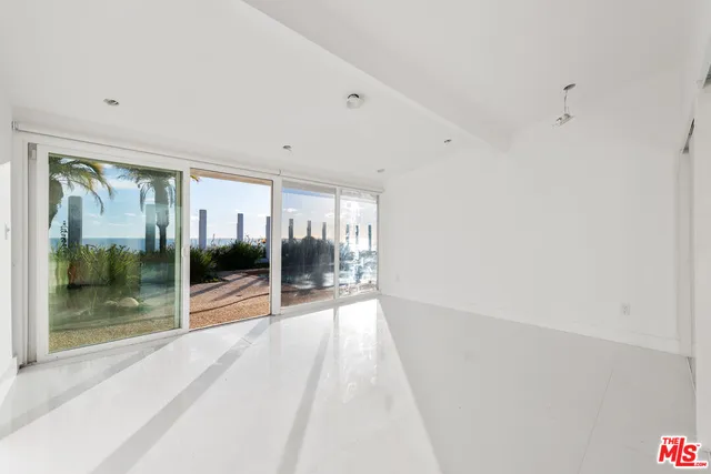 a bedroom with a bed and glass door