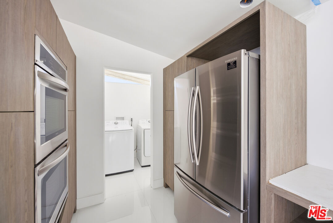 6246 Trancas Canyon Road Malibu, CA 90265 - Photo 19 of 23 a view of a refrigerator in kitchen and an empty room