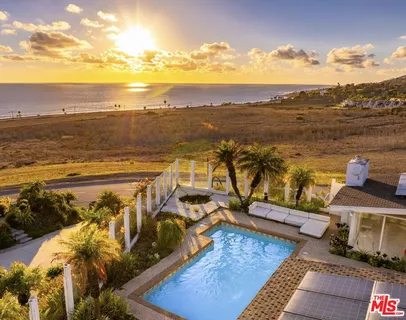 a view of swimming pool with outdoor seating and plants
