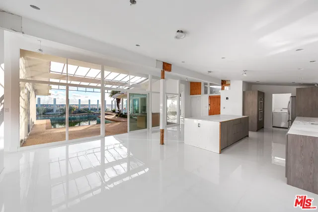 a kitchen with stainless steel appliances wooden cabinets and window